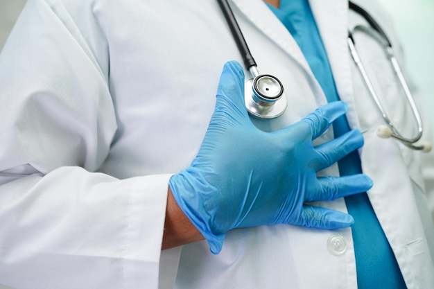 Asian woman doctor holding red heart for health in hospital