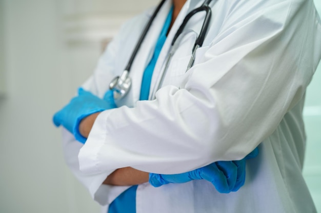 Asian woman doctor holding red heart for health in hospital