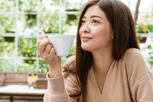 Asian woman drink in coffee shop