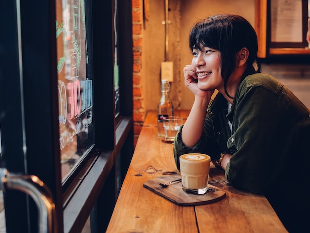 Asian woman drinking coffee in  coffee shop cafe  