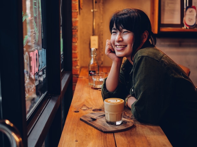 Asian woman drinking coffee in  coffee shop cafe  