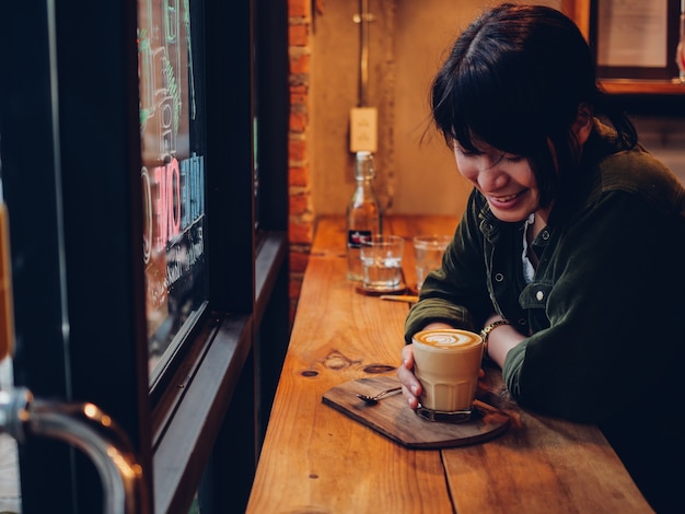 Asian woman drinking coffee in  coffee shop cafe  