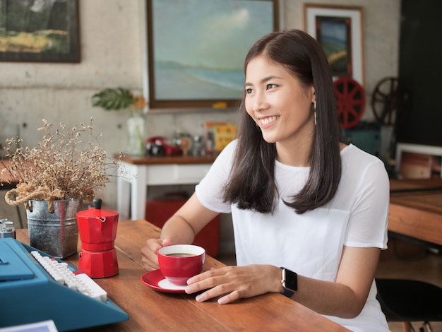 Asian woman drinking coffee in  coffee shop cafe