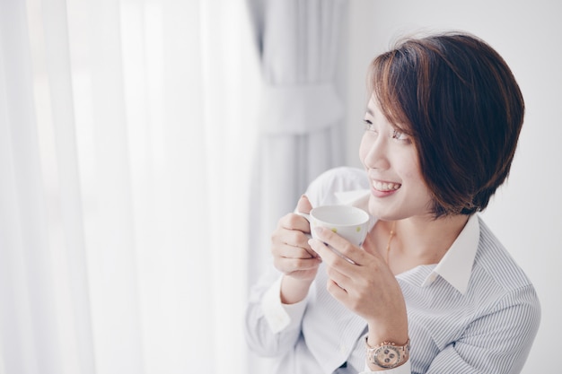 Asian woman drinking coffee