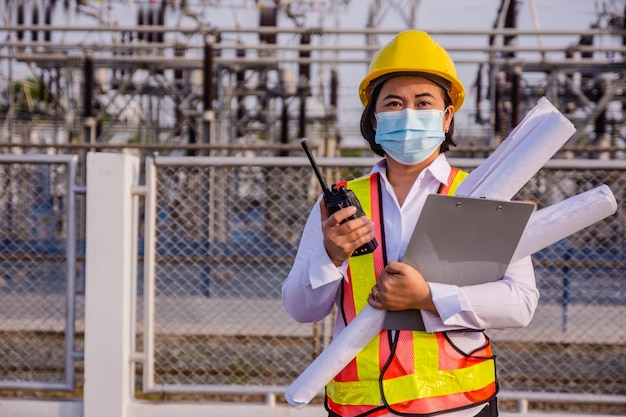 Asian woman Electrician Engineer standing on factory power plant Portrait Electrician Engineer concept