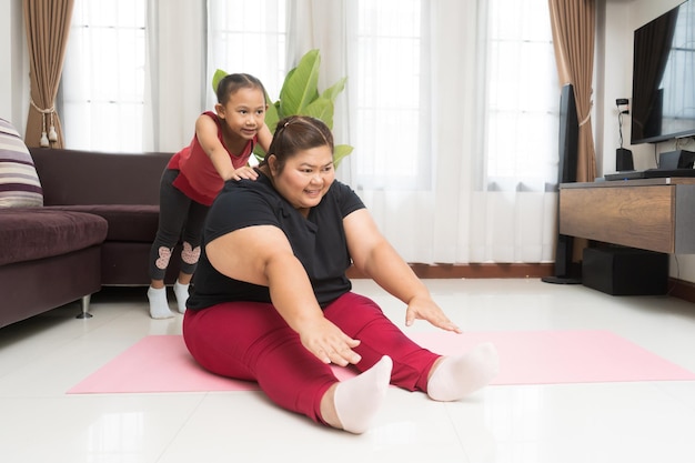 Asian woman fat with little girl exercising weight loss and recreation idea concept