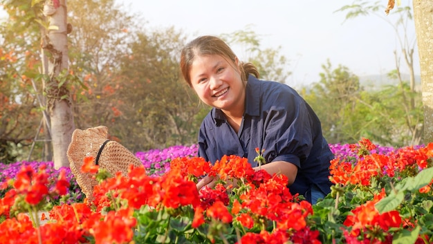 Asian woman feel happy to work in her flower garden business