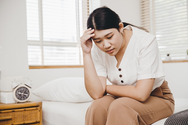 Asian woman feel stress and anxiety fear or panic at home bedroom