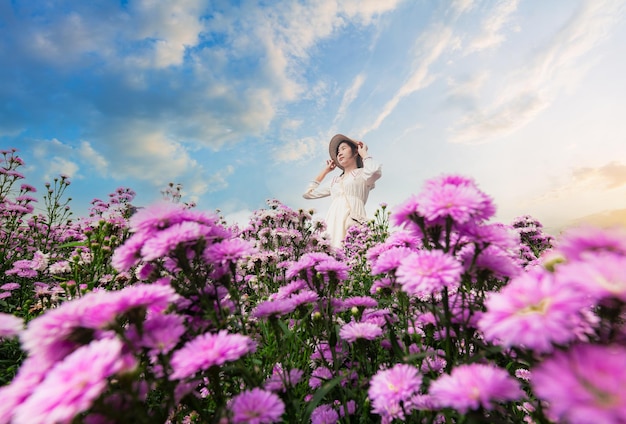 Asian woman and flower field,Beautiful asian girl Taking pictures in a flower farm. Happily in Chian