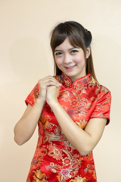 Asian woman greeting in traditional Chinese or cheongsam 