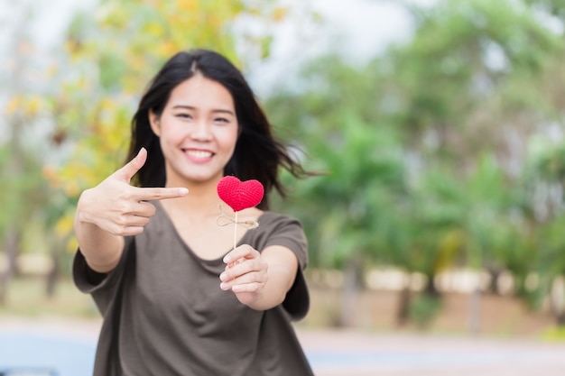 Asian woman hand hold beautiful red heart sweet loving symbol 