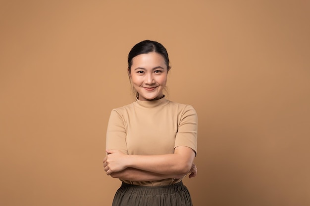 Asian woman happy confident looking at camera isolated on beige background