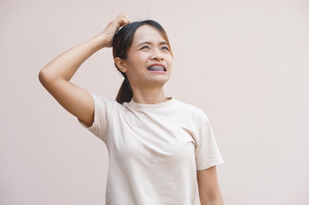 Asian woman has itchy head from dandruff