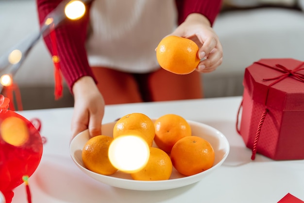 Asian Woman holding mandarin oranges with red gift box thankful present Lunar New Year Chinese traditional holiday Lunar new year culture