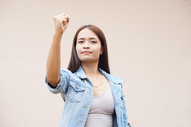 Asian woman holding up two fingers