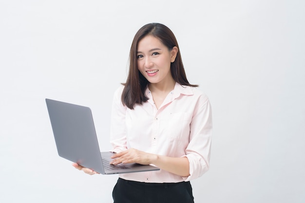 An asian woman is holding laptop computer on white Studio background