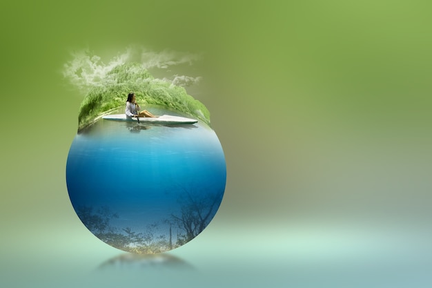 Asian woman paddling a kayak on the lake with an underwater view. Environment concept