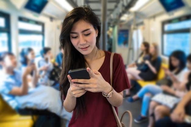 Asian woman passenger using the social network 