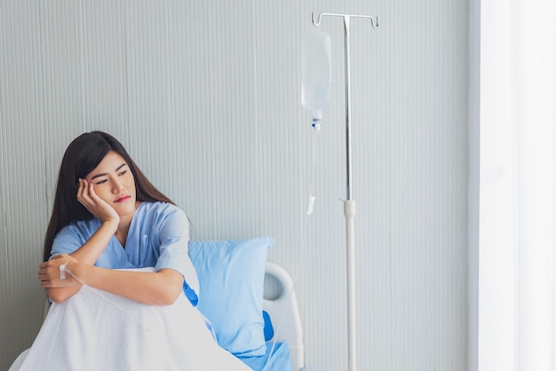 Asian woman patients is upset and sitting in patient's bed with alone