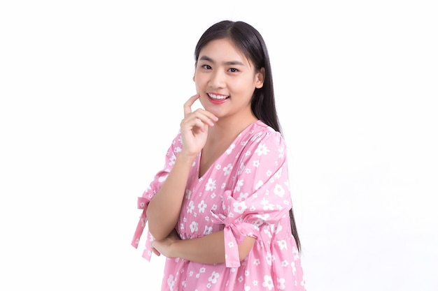 Asian woman in pink dress and black long hair smile show beautiful skin on white background