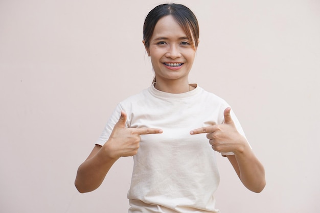 Asian woman pointing finger at herself