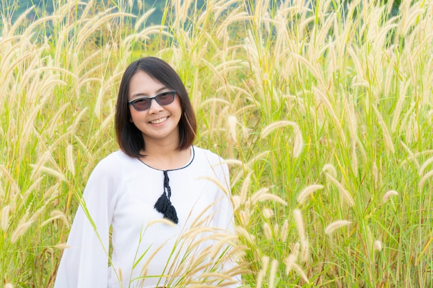 Asian woman relax in grass field.