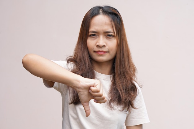 Asian woman's hand raising thumbs as a sign of dislike