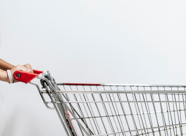 An Asian woman's hand with an empty shopping cart.This image is Soft Focus.