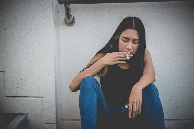 Asian woman sad from loveShe smoking because stress from boyfriendHeartbreak woman concept