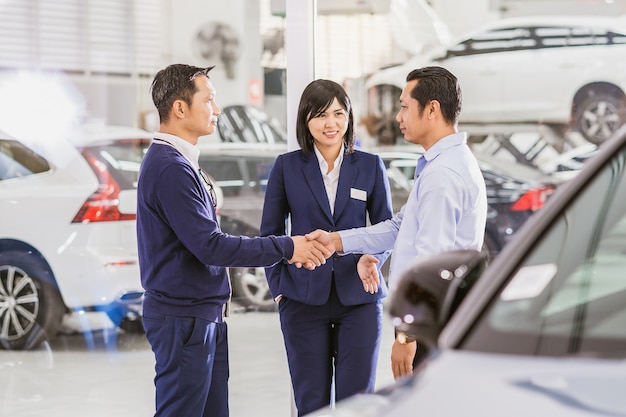 Asian woman sales representative introducing the service to customer Mechanic leader handshake