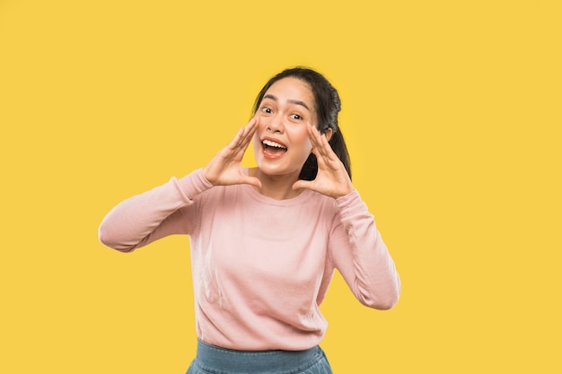 Asian woman screaming with two hands near mouth