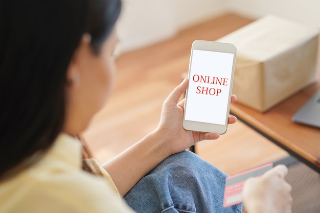 Asian woman shopping online on smartphone