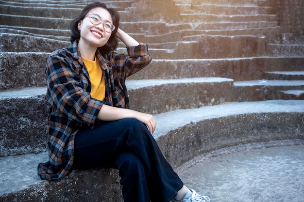 Asian woman sitting on the stone steps