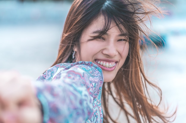 Asian woman smiling outdoors