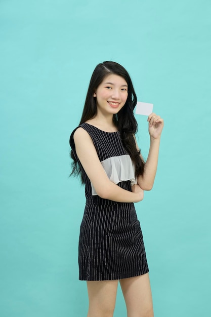 Asian woman smiling showing presenting credit card for making payment or paying online business