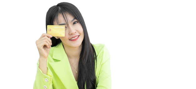 Asian woman standing and thinking idea using credit card on white background Asian woman showing presenting credit card for making payment Asian shopaholic women wearing green suit