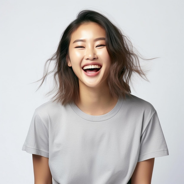 asian woman stands in front of a white background with her hands on her hips