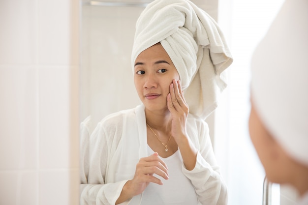 Asian woman taking care her face