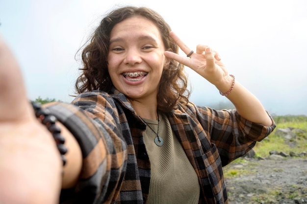 Asian woman taking selfportrait while hiking in the mountains