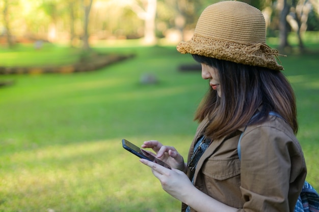 Asian woman traveler using smart mobile phone in the archaeological 