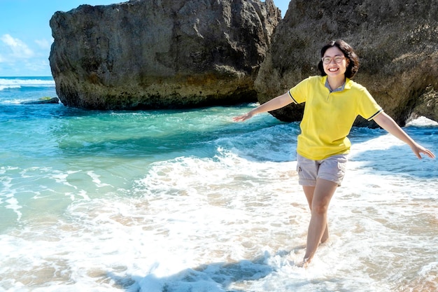 Asian woman traveling on the beach