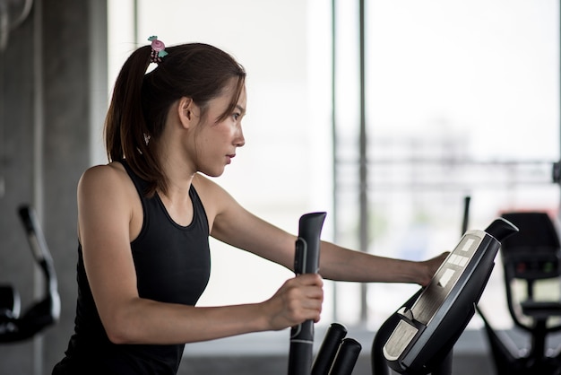 Asian woman on treadmill in the gym