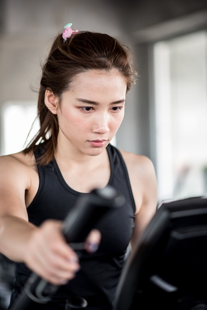 Asian woman on treadmill in the gym