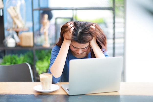 Asian woman using computer laptop and drink coffee work from home concept