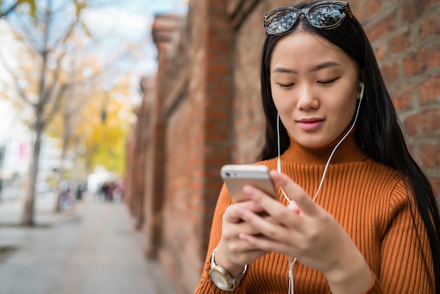 Asian woman using her mobile phone.