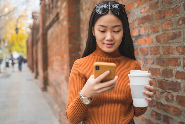 Asian woman using her mobile phone