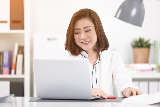 Asian woman using laptop at home,