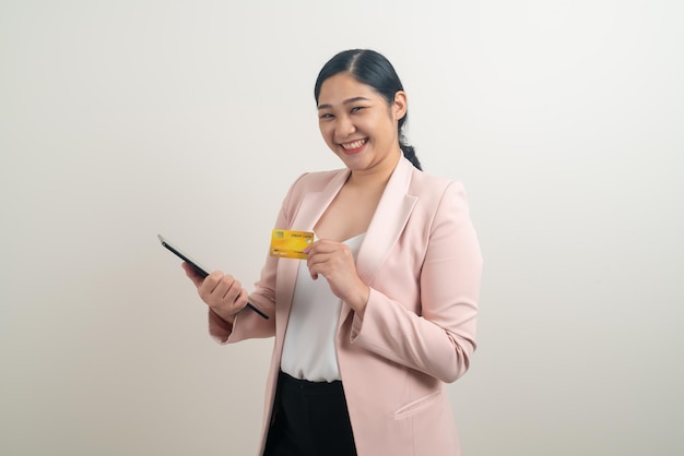 Asian woman using smartphone with hand holding credit card