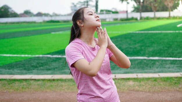 Asian woman warming up before running