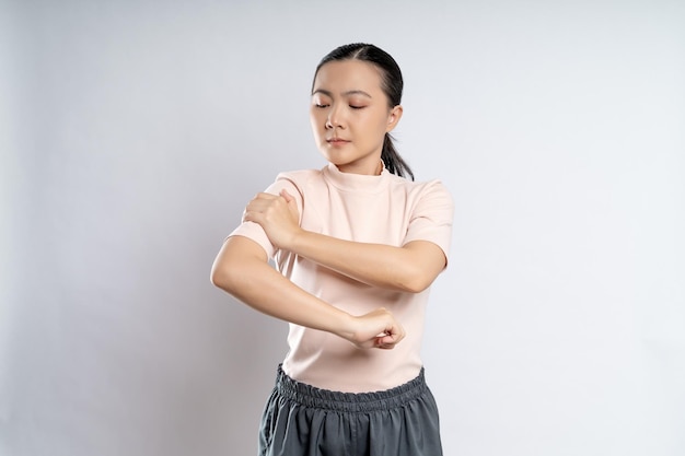 Asian woman was sick with body pain standing isolated on white background